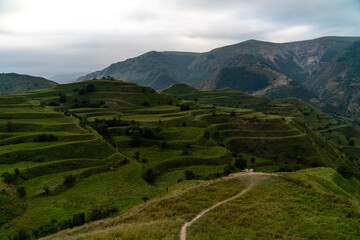 Obraz premium Chokhsky terraces Dagestan. Landscape of mountainous Dagestan with terraced fields and peaks mountains in the distance.