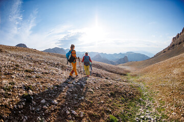 climbers with backpacks in the mountains. Tourists travel to the mountains. Active recreation in...