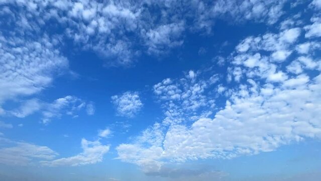 Blue sky with white clouds background. Moving Cloud, time-lapse.