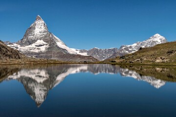 Reflection of the Matterhorn Mountain in a lake, Swiss Alps