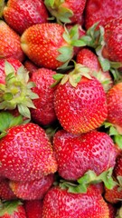 Pile of strawberries on the market. strawberry background texture or wallpaper