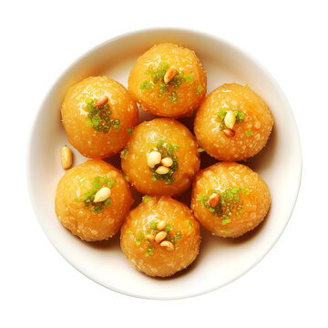 Close-up of Indian traditional sweet 'Laddu' served in a white bowl, golden brown color and syrupy texture