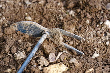 High angle view of small hoe gardening tool at vegetable bed of home garden at Swiss City of Zürich on a cloudy spring morning. Photo taken April 28th, 2024, Zurich, Switzerland.