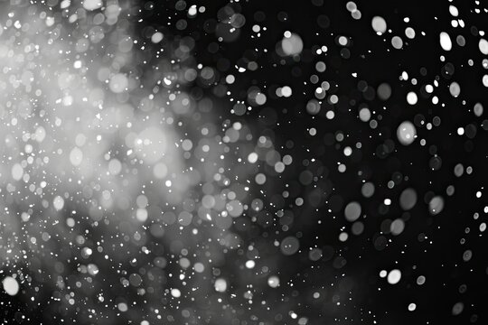 Snowflakes falling in spacelike black and white photo