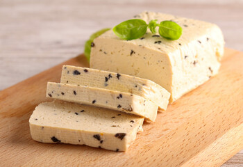 Basil tofu, sliced on  board