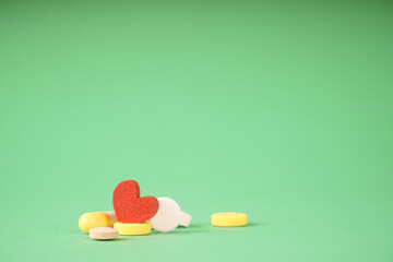 Heart and pills, a photo symbolizing medical treatment of the heart. Help with heart pain
