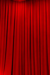 red theater curtain that dropped down as a straight line. Background for inserting text, empty spaces.	