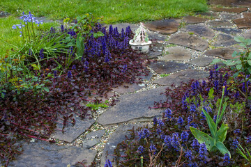 stone paved garden path and flowers - springtime