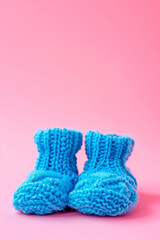 blue knitted baby booties. Selective focus.