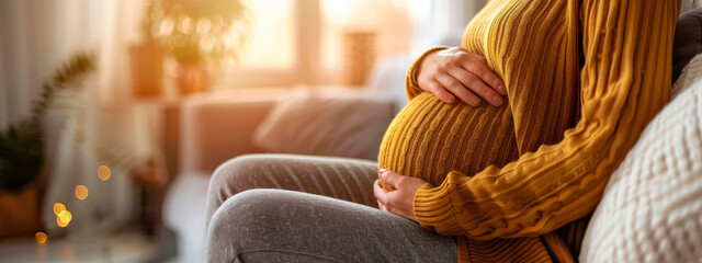 Obraz premium pregnant woman sitting on the sofa. Selective focus.