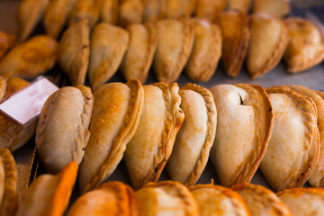 Freshly baked empanadas with different fillings for sale - 798748087