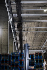 Forklift operator in bustling industrial storage facility