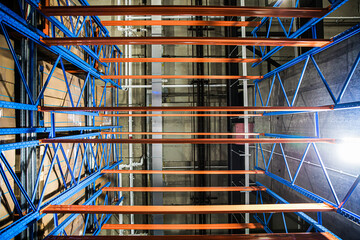 Industrial Shelves: Symmetrical view of empty industrial warehouse shelving