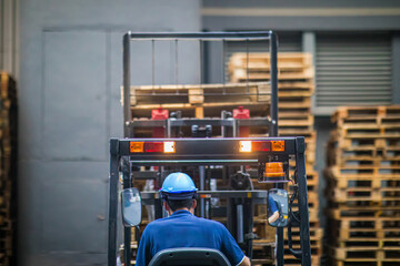 Forklift operator in bustling industrial storage facility
