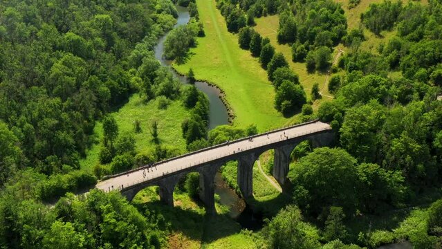 Headstone Viaduct aka Monsal Viaduct disused rail bridge now trail crossing Monsal Dale. Peak Distrtict National Park, England. Video fly up out