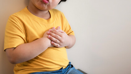 fat kid put yellow tight shirt chest pain severe heartache, heart disease or heart attack. concept...