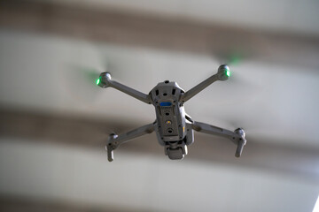 small drone flying indoors at factory