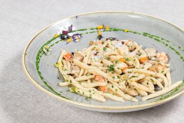 Strozzapreti typical Italian homemade pasta with clams, prawns, prawns, fresh fish