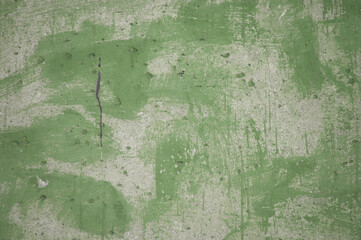 concrete wall and traces of green paint close-up