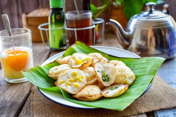 Kanom Krok, Thai Coconut Puddings, thai traditional breakfast set soft boiled egg and hot tea, retro style