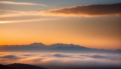 Obraz premium sunrise golden clouds in the sky with a silhouette of mountains and fog