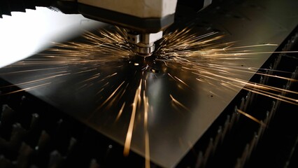 A laser cutting machine cuts a metal plate. High-tech sheet metal production process using a laser...