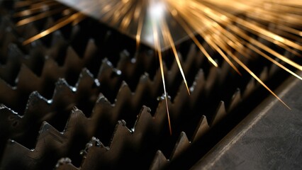 Modern industrial technology concept. Welding sparks. Close-up of a laser machine, sparks,...