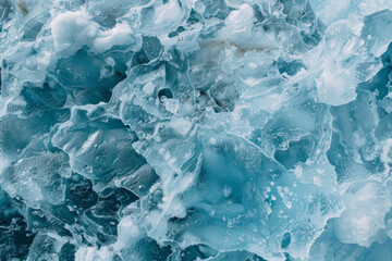 Obraz premium Textured surface of an iceberg, showcasing its rugged edges and icy formations. Iceberg textures offer a crisp and invigorating backdrop
