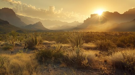 Muted tones of amber and rust fill the air as the sun sets behind the rugged peaks of the desert mountains..