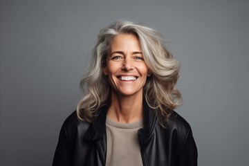 Portrait of happy senior woman with grey hair looking at camera and smiling