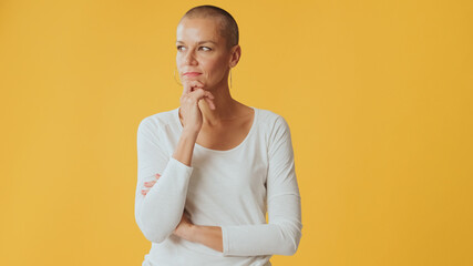 Young hairless woman, thinks over problem, remembering something, looking at camera isolated on...