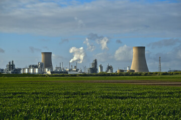HDR Oil refinery, cooling towers, with smoke.