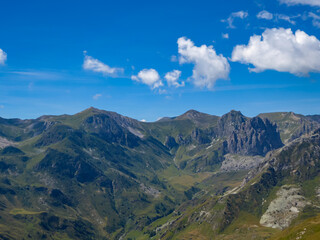 Panoramic mountain landscape of Cottian Alps in Grana Valley (Valle Grana) with clear blue sky on a sunny summer day, Castelmagno, Cuneo, Piedmont, Italy. Alpine pasture of Western Italian Alps