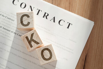 Chief Knowledge Officer CKO Contract With Wooden Block Letters on Desk