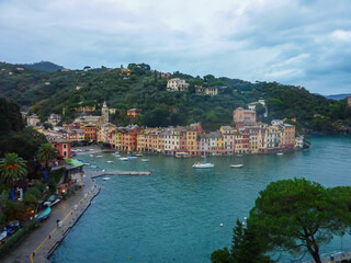 Aerial view of coastal port town of Portofino at the Ligurian Mediterranean Sea, Italy, Europe. Lucury yachts and boats in the small harbor. Overcast during winter season. Travel destination