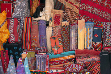 Moroccan carpets and rugs, handwoven by the berber tribes on display. Variety of carpets styles,...