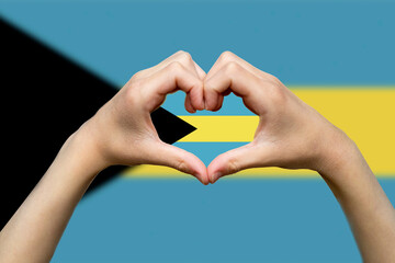Bahamas flag with two hands heart shape, express love or affection concept, support or donate to