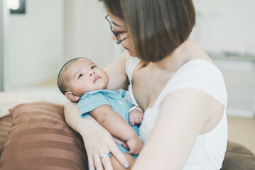 Adorable asian baby boy relaxing with mom at home,Newborn child