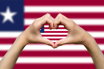 Liberia flag with two hands heart shape, vector design, express love or affection concept