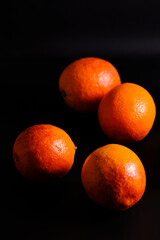 Fresh Juicy Blood Oranges on Dark Background