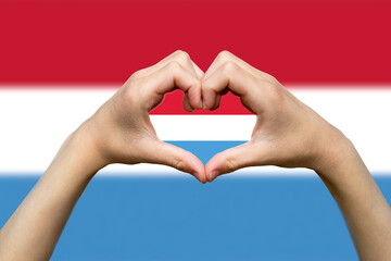 Luxembourg flag with two hands heart shape, patriotism and nationalism idea, express love 