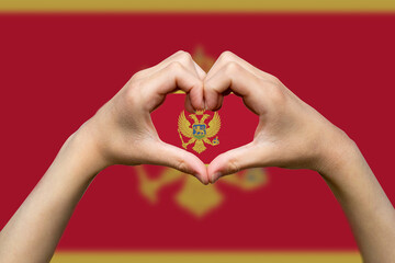 Montenegro flag with two hands heart shape, support or donate to Montenegro, vector design, hand 