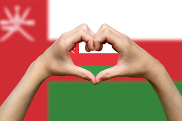 Oman flag with two hands heart shape, support or donate to Oman, vector design, hand heart love 