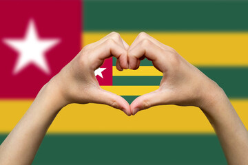 Togo flag with two hands heart shape, patriotism and nationalism idea, hand heart love sign