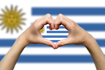 Uruguay flag with two hands heart shape, vector design, express love or affection concept, hand 