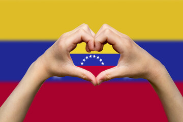 Venezuela flag with two hands heart shape, patriotism and nationalism idea, support or donate to 