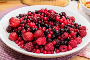 Assortment of Fresh Forest Berries on a Rustic Wooden Surface