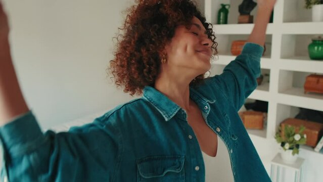 Close-up young smiling woman dancing in living room