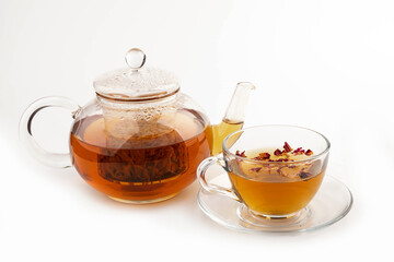 Tea made from tea rose petals in a glass bowl on white background