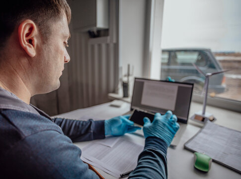 professional in gloves works on a laptop, indicating a rapid and precise analysis in a lab environment